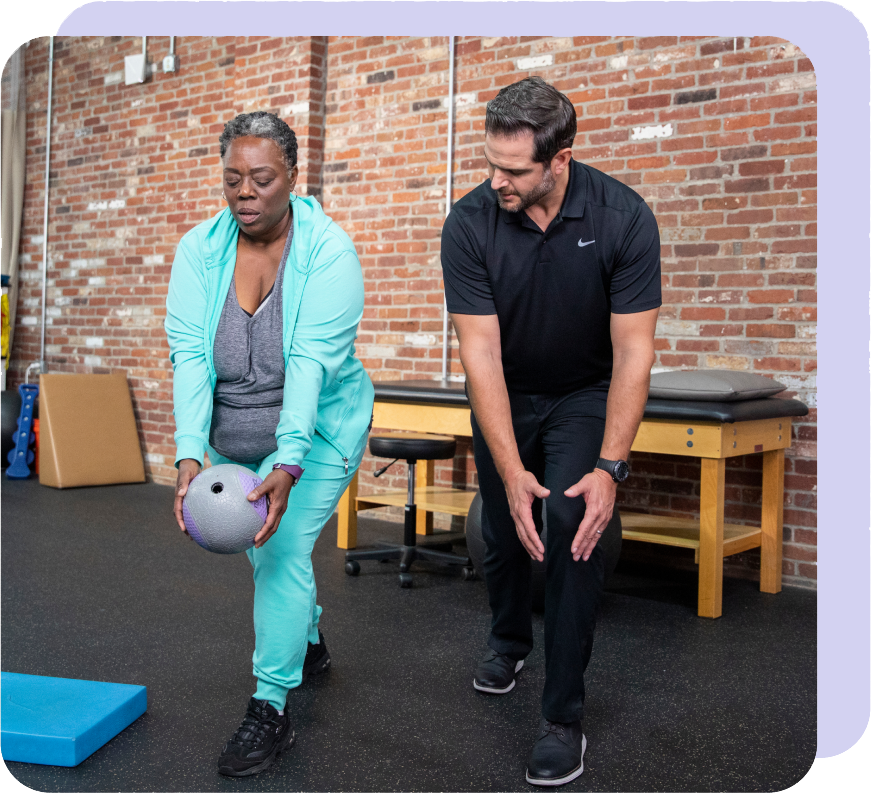 woman in a teal jumpsuit doing medicine ball exercises